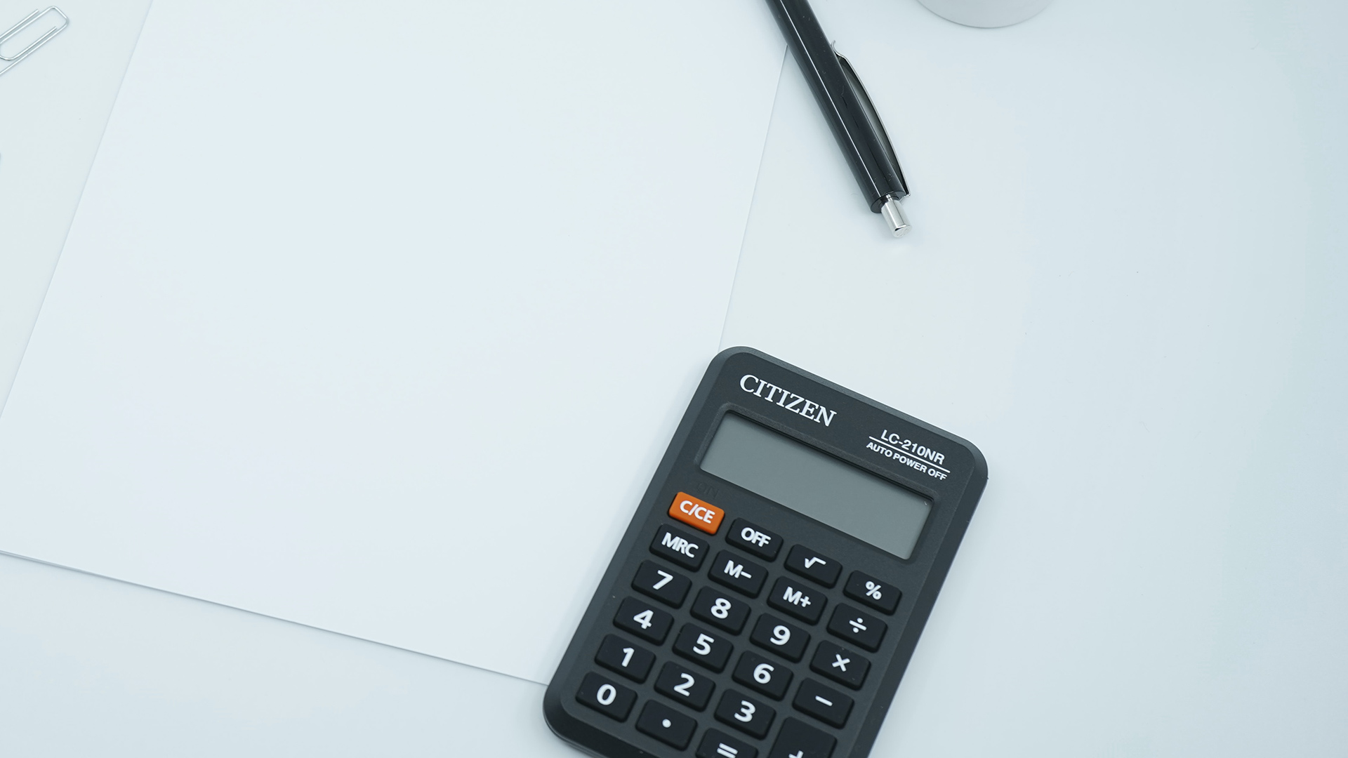Paper, Pen and Calculator on table